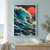 Huge turquoise wave curling around a small illuminated lighthouse on a rocky outcrop beneath a coral-red sun and distant birds.; frame shown for styling only