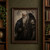 White-haired bearded armored figure with two black ravens against a pale patterned wall.; frame shown for styling only