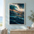 Textured curling ocean wave with bright foamy spray and coral-orange and copper-gold streaks over dark blue water.; frame shown for styling only