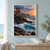 A coral-red lifeguard lookout on stilts stands above dark rocks and foaming turquoise waves, with a rescue float beside its doorway.; frame shown for styling only