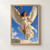 Winged woman in flowing white drapery raising a laurel wreath against a bright blue sky.; frame shown for styling only
