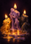 Three violet, amber, and charcoal wax spirits with lit wicks gather around a reflective pool of melted wax.