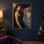 Dark-haired woman in a deep teal gown lifting a gauzy drape with a coastal landscape and small bird.; frame shown for styling only