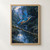 Blue kingfisher flying above a shaded stream, with raised wings, a mossy branch, falling droplets, and a reflective pool.; frame shown for styling only