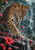 Frontal leopard stepping through heavy rain, its forepaw planted on a wet ledge among red tropical flowers and petals.