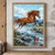 A chestnut horse jumps rightward above a rocky stream, with its mane blown back, white spray below, and mountains in the distance.; frame shown for styling only
