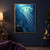Glowing turquoise jellyfish with long trailing tendrils above a small diver reaching up from a rocky ledge in dark blue water.; frame shown for styling only