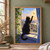 Black cat on a windowsill reaches toward a yellow moth outside an open window, framed by a trailing plant and blue curtain.; frame shown for styling only