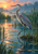 A gray-blue heron stands among reeds and cattails in reflective marsh water beneath a bright peach-and-amber dawn sky.