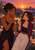 Two adult women smile and clink stemmed glasses on a rooftop at sunset, with a city skyline and foliage behind them.