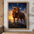 Large russet bull standing on a rocky rise beneath a low golden sunrise and scattered stars in an indigo sky.; frame shown for styling only
