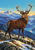 Chestnut stag with branching ivory antlers standing on a rocky, snow-dusted alpine ridge before layered blue-violet mountains and a turquoise dawn sky.
