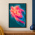 A luminous abstract flower-like burst of coral, peach, fuchsia, and blue petal forms against deep teal.; frame shown for styling only