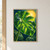 Large green monstera leaf with natural openings silhouetted against a bright golden sun disk and dark green background foliage.; frame shown for styling only