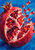 An opened pomegranate with glossy ruby-red arils and pale pith, surrounded by scattered seeds on a bright blue background.