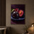 Three dark plums on a blue ceramic dish against a dark background, including one split open to show magenta flesh and a brown pit.; frame shown for styling only