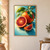 Ruby-fleshed cut orange and small wedge beside a whole orange partly covered by glossy green leaves on teal.; frame shown for styling only