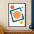 Abstract geometric poster with an apricot circle inside an open tilted teal square, surrounded by smaller colored circles and cobalt bars on white.; frame shown for styling only