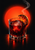 Faceted glass of dark red drink with a large ice sphere, charred orange slice, and curling smoke against a red glow on black.