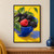 Blackberries and a prominent red raspberry in a cobalt-blue bowl, with leafy stems and water droplets against yellow.; frame shown for styling only