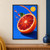 Large halved blood orange with glossy red-orange segments and a green leaf, surrounded by upward-sweeping juice droplets on cobalt blue.; frame shown for styling only