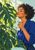Adult woman with short dark curls holding a glass mister beside large split leaves, with “SUNROOM PAUSE” lettering at the bottom.
