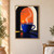 Oversized cobalt cup with curling steam beneath an arched orange-red sunset window, above a dark counter with a long blue-violet shadow.; frame shown for styling only
