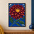 Large burgundy-red dahlia with a golden-yellow center against cobalt blue, surrounded by green stems, broad leaves, and small white star-shaped flowers.; frame shown for styling only