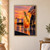 A hand garnishes a tall amber citrus spritz with an orange wheel against a sunset waterfront, with rosemary and a second glass nearby.; frame shown for styling only