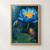 An open blue water lily with a golden-orange center, a closed bud, and a broad lily pad above dark water dotted with rain rings.; frame shown for styling only
