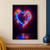 A glowing blue glass-tube heart mounted against a dark wall, surrounded by orange-red light with colored reflections below.; frame shown for styling only