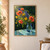 Colorful bouquet of coral poppies, blue-purple flowers, and yellow daisy-like blooms in a transparent blue pitcher on a turquoise tabletop.; frame shown for styling only