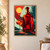 Faceted ruby-red bottle beside a small stemmed glass of red-orange drink with a citrus slice against abstract shapes.; frame shown for styling only