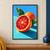 A ruby-red cut blood orange with droplets sits in front of a whole orange and green leaves on a turquoise surface.; frame shown for styling only