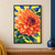 Large coral-orange dahlia with a dark plum center, two cobalt buds, green leaves, and blue rays on a yellow background.; frame shown for styling only