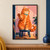 Large ginger tabby with a turquoise collar raises one paw while seated on a dark stool in a pink doorway-like interior.; frame shown for styling only