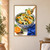 A patterned blue-and-white bowl of citrus, shaved fennel, greens, and olives, with a spoon lifting a bite and a cut orange beside it.; frame shown for styling only