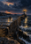 Lit lighthouse at the end of a long stone breakwater, with rough reflective water and clouded dusk sky.