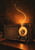 Vintage tabletop radio with a glowing circular dial and a golden star-speckled trail rising into a warm, dark room.