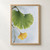 Close-up of a rain-beaded green ginkgo leaf with radiating veins and a smaller golden leaf on a curved stem against a pale, rain-streaked background.; frame shown for styling only