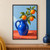 Cobalt-blue pitcher with a leafy branch bearing three oranges on a coral tabletop against a pale-blue wall.; frame shown for styling only