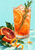 A ribbed glass of sparkling orange drink with rosemary and a citrus wheel, beside blood-orange slices and curling zest.
