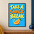 Large hand-painted words “TAKE A SNACK BREAK” above an orange wedge with a green leaf on a bright blue background.; frame shown for styling only
