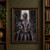 Gray-skinned, pointed-eared woman with pale braided hair holds an open compass amid floating chains and metal objects in a dark interior.; frame shown for styling only
