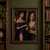 Woman in a deep blue gown holding an open compact beside a gold-framed portrait with darkened eyes.; frame shown for styling only