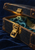 Open dark leather travel case with a large brass clasp, teal fabric, and a pressed fern on deep blue fabric.