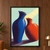 Taller cobalt-blue vase beside a shorter vermilion-orange vessel, their openings nearly touching against a pale mint background.; frame shown for styling only