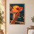 Hand raising a ruby-orange spritz in a coupe before a setting sun, citrus branches, and a teal coastal landscape.; frame shown for styling only