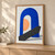 Cobalt-blue upright arch with an apricot semicircle inside its opening and a diagonal charcoal slab on a pale background.; frame shown for styling only
