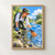 Gloved woman kneels beside a clear stream, lifting an orange bottle among rocks, reeds, and trees.; frame shown for styling only